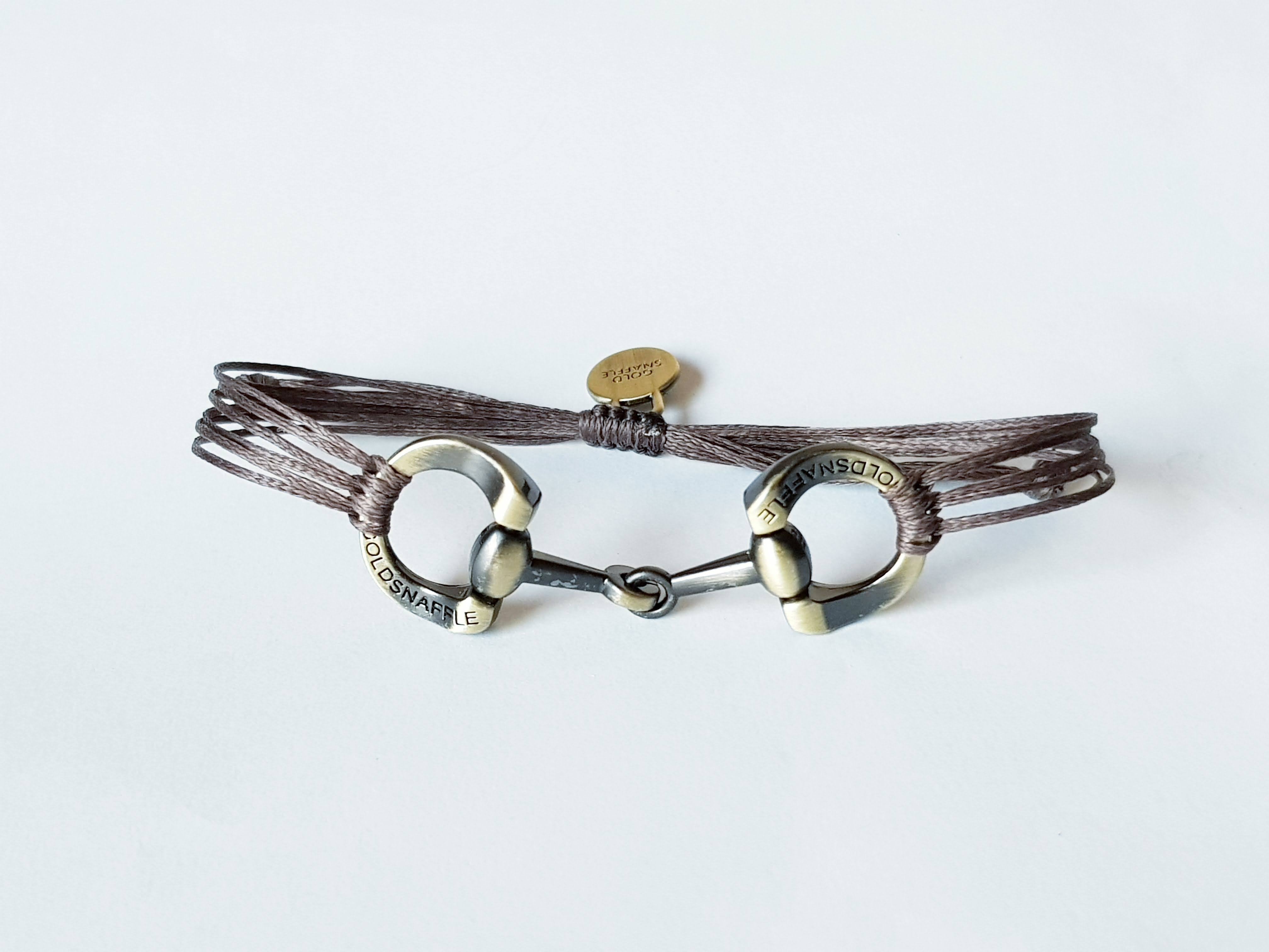 Brushed gold horse bit snaffle bracelet in leather string