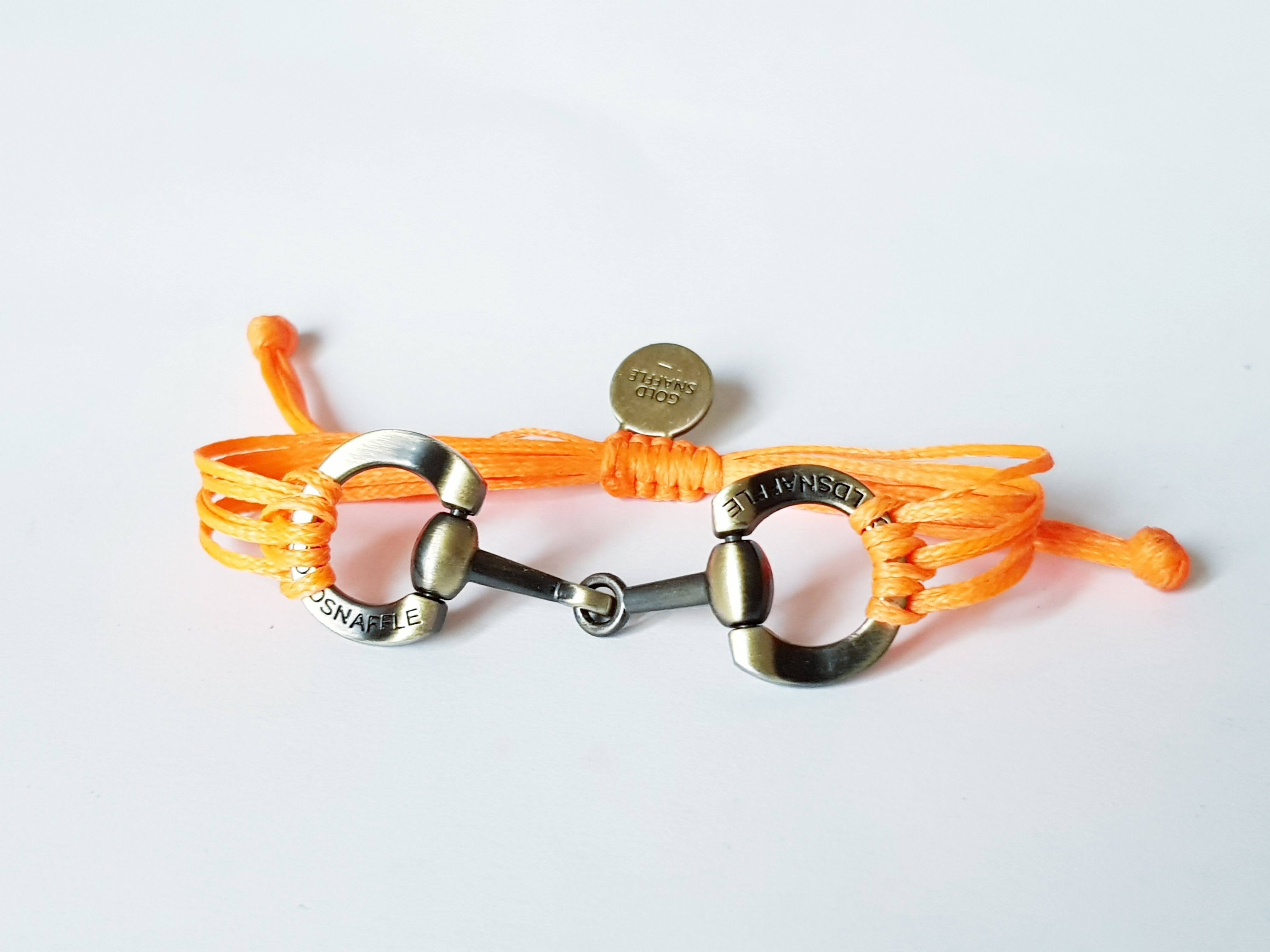 Brushed gold horse bit snaffle bracelet in leather string
