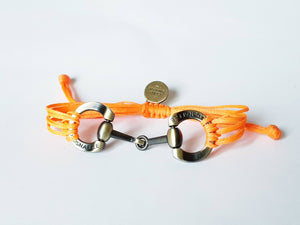 Brushed gold horse bit snaffle bracelet in leather string