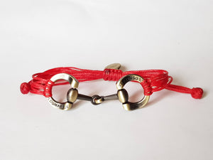 Brushed gold horse bit snaffle bracelet in leather string