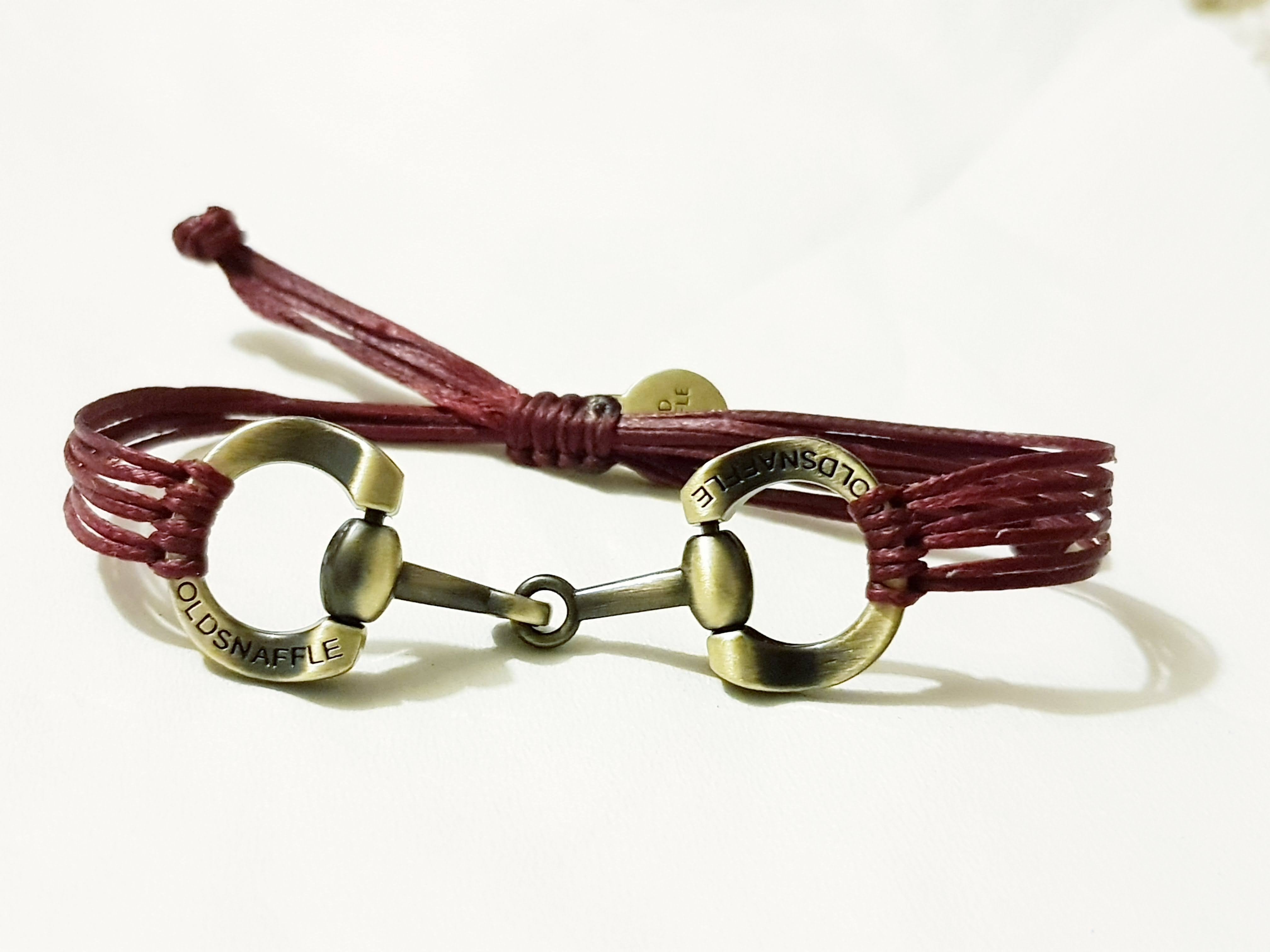 Brushed gold horse bit snaffle bracelet in leather string