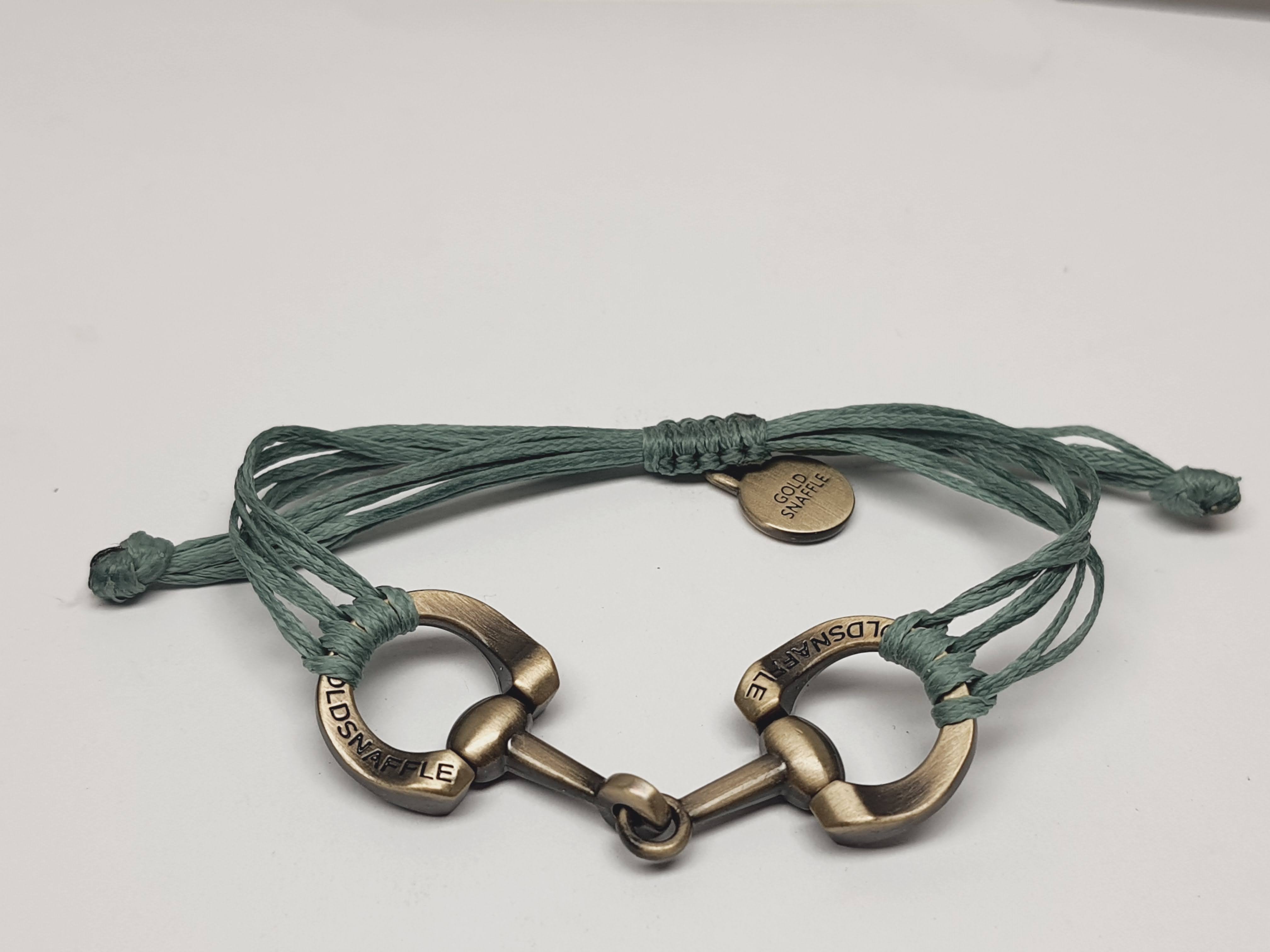 Brushed gold horse bit snaffle bracelet in leather string