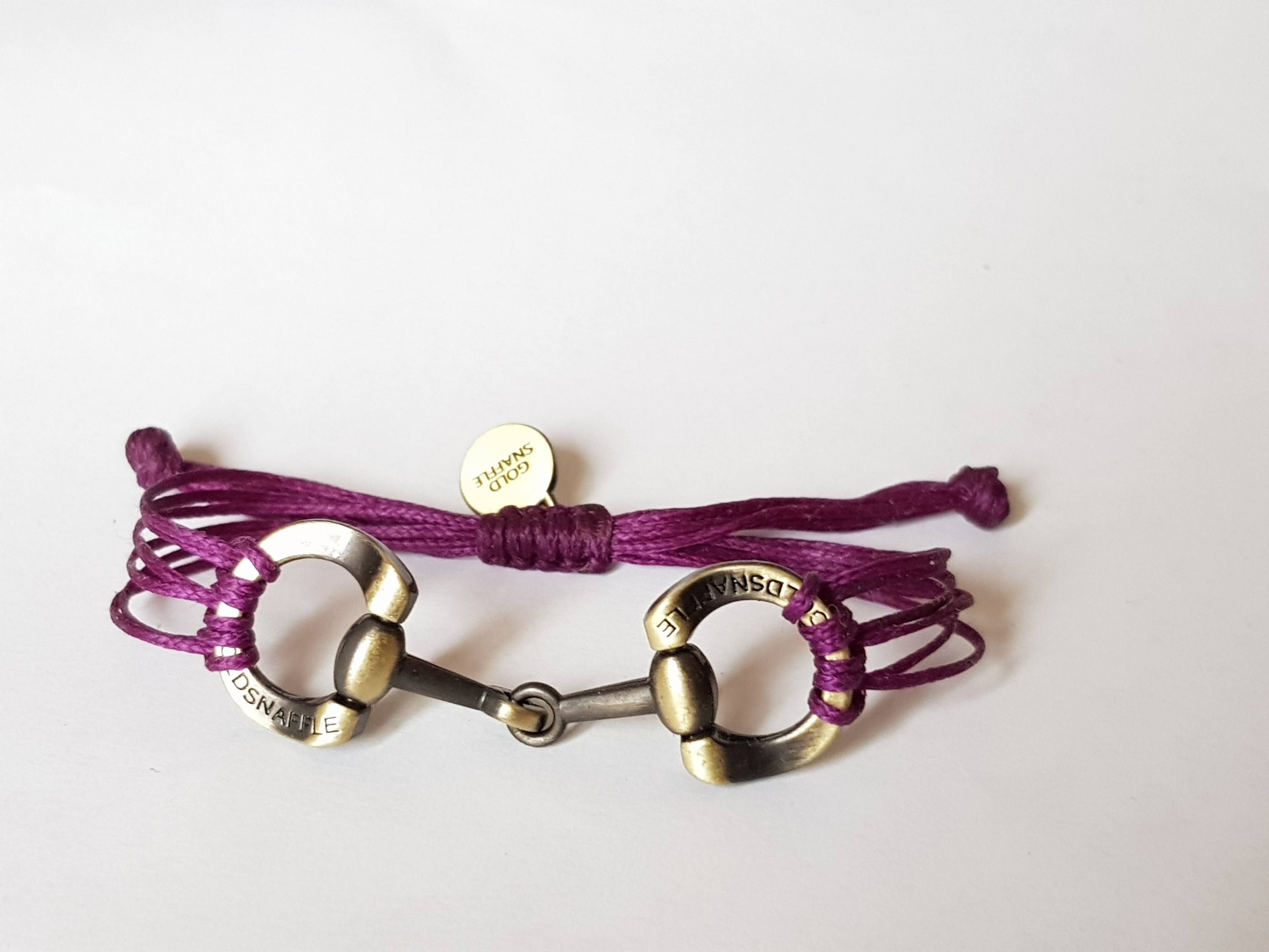 Brushed gold horse bit snaffle bracelet in leather string